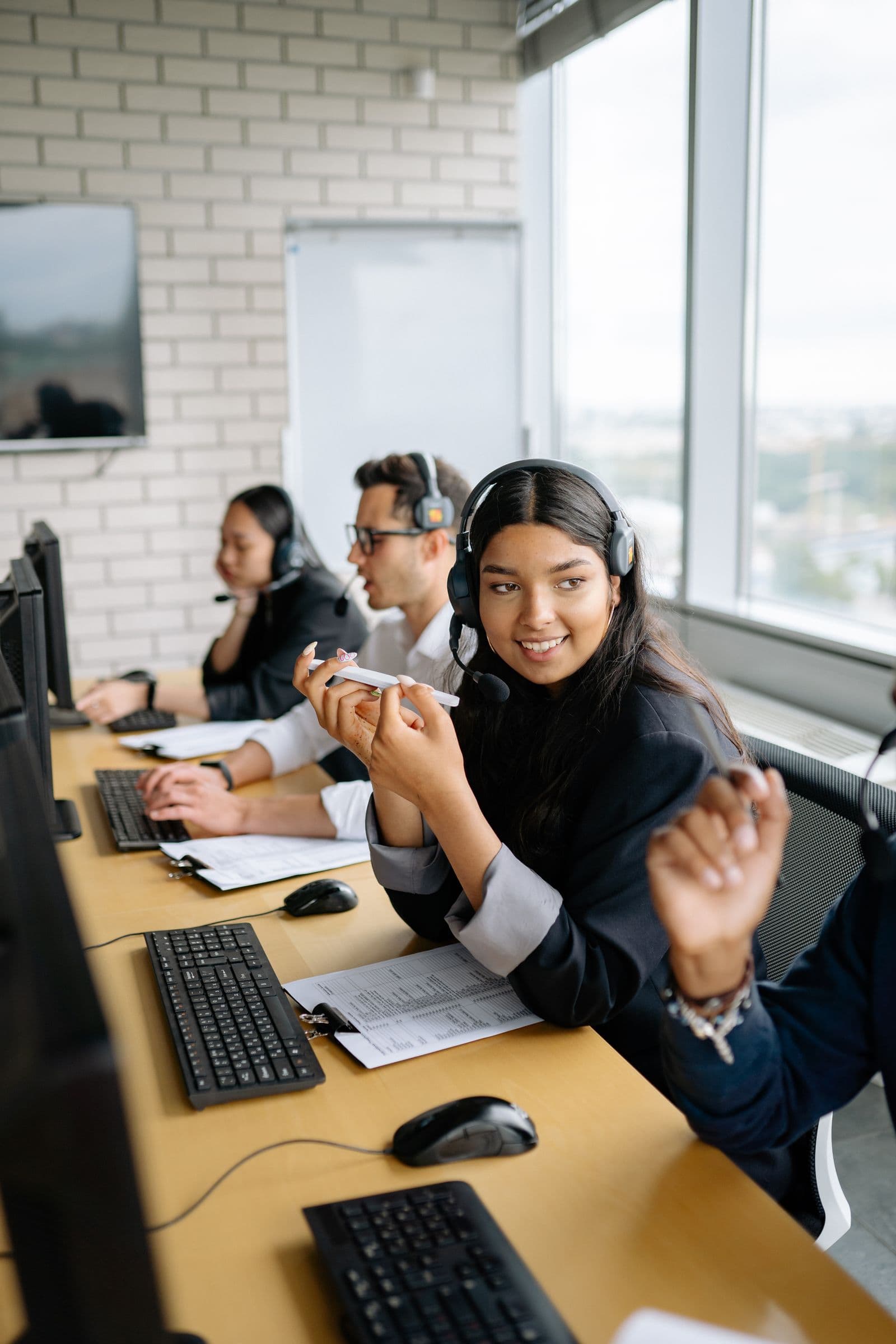 A support floor with agents wearing headsets at their desks. Stock photograph, not the iGaming Operations team.