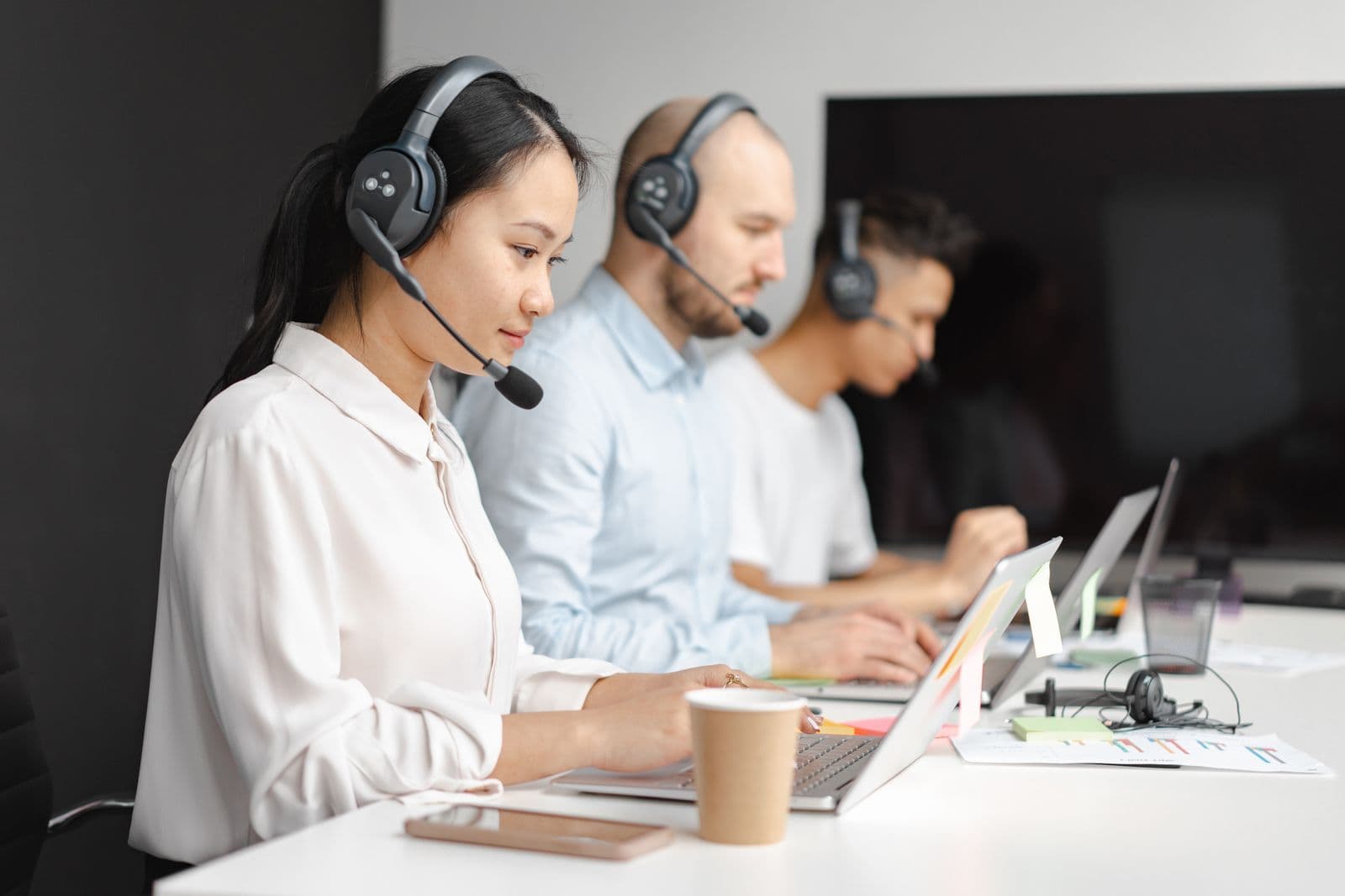 A customer-support agent wearing a headset and laughing during a call. Stock photograph, not an iGaming Operations employee.
