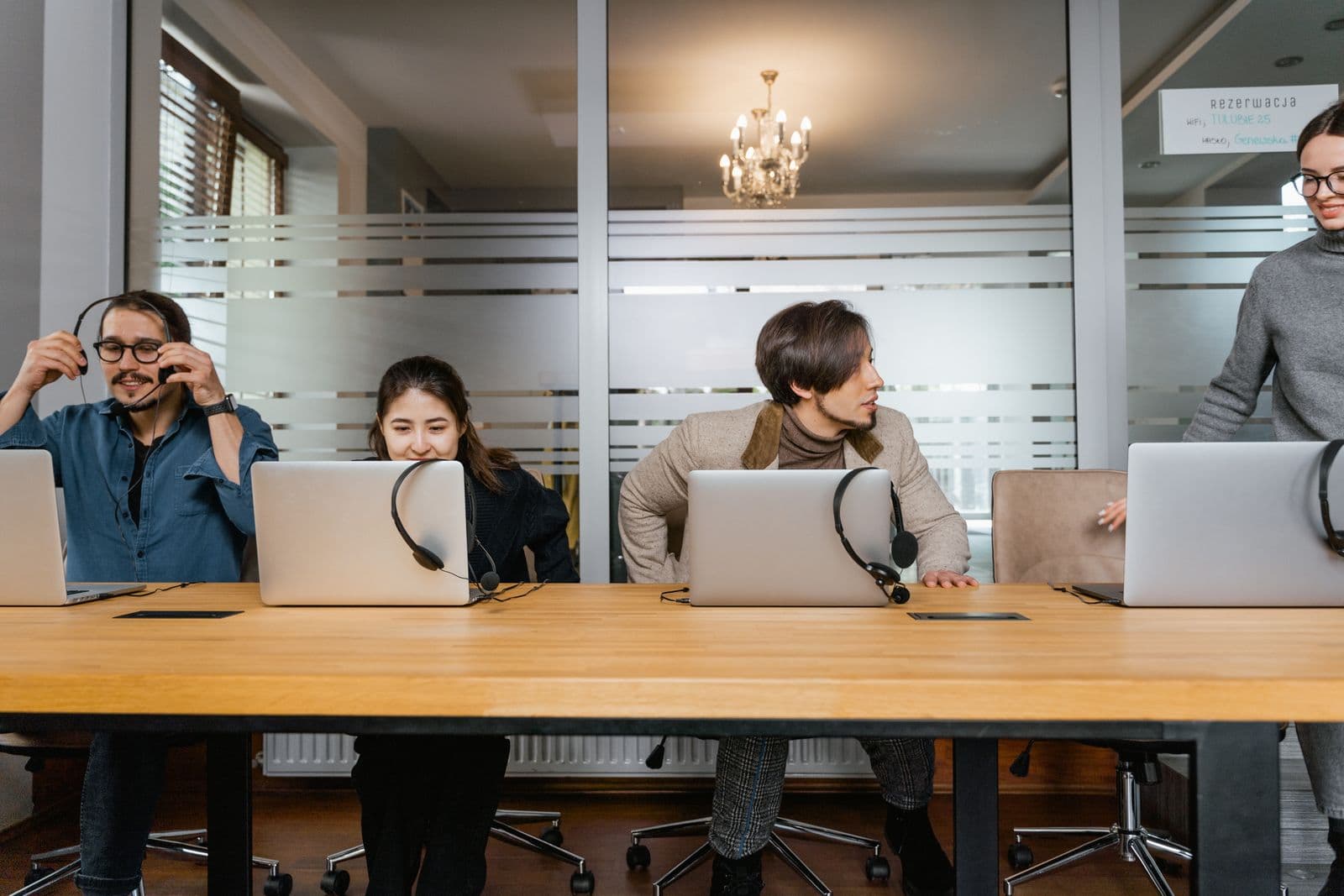 A customer-support agent wearing a headset and looking aside from the desk. Stock photograph, not an iGaming Operations employee.